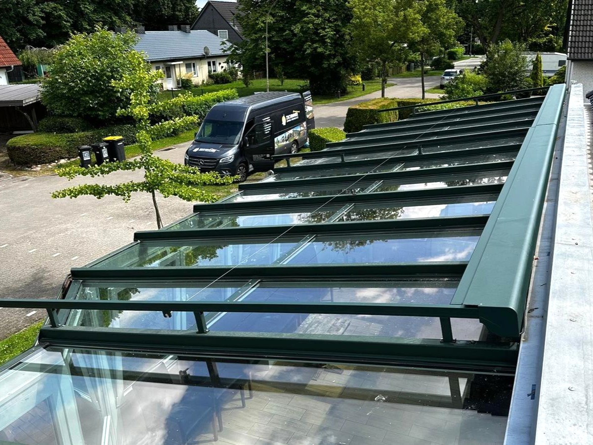 Große Glasfläche des Wintergartens mit geöffneter Oberglasmarkise
